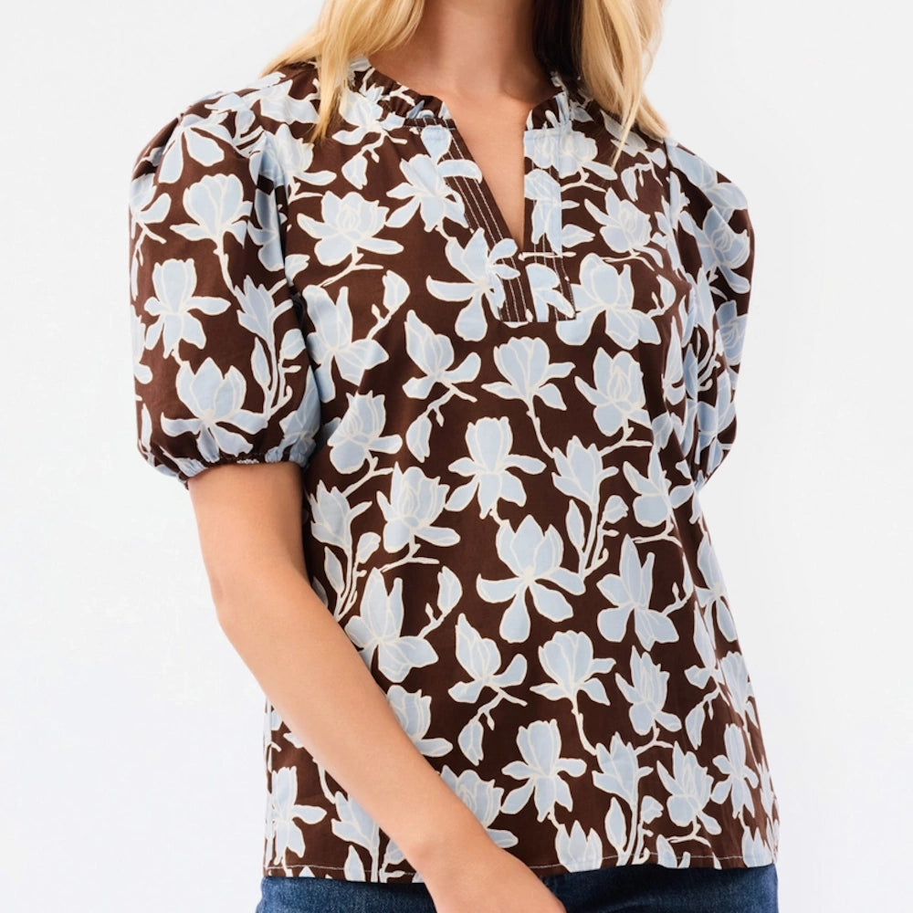 Brown puff-sleeve top with light blue floral print and split neckline.