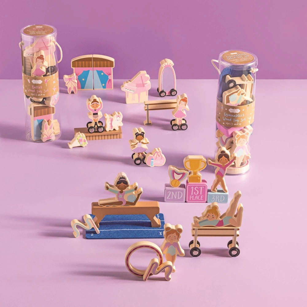 Gymnastics wood toy set with diverse figures, balance beam, and trophy on purple background for active creative play.