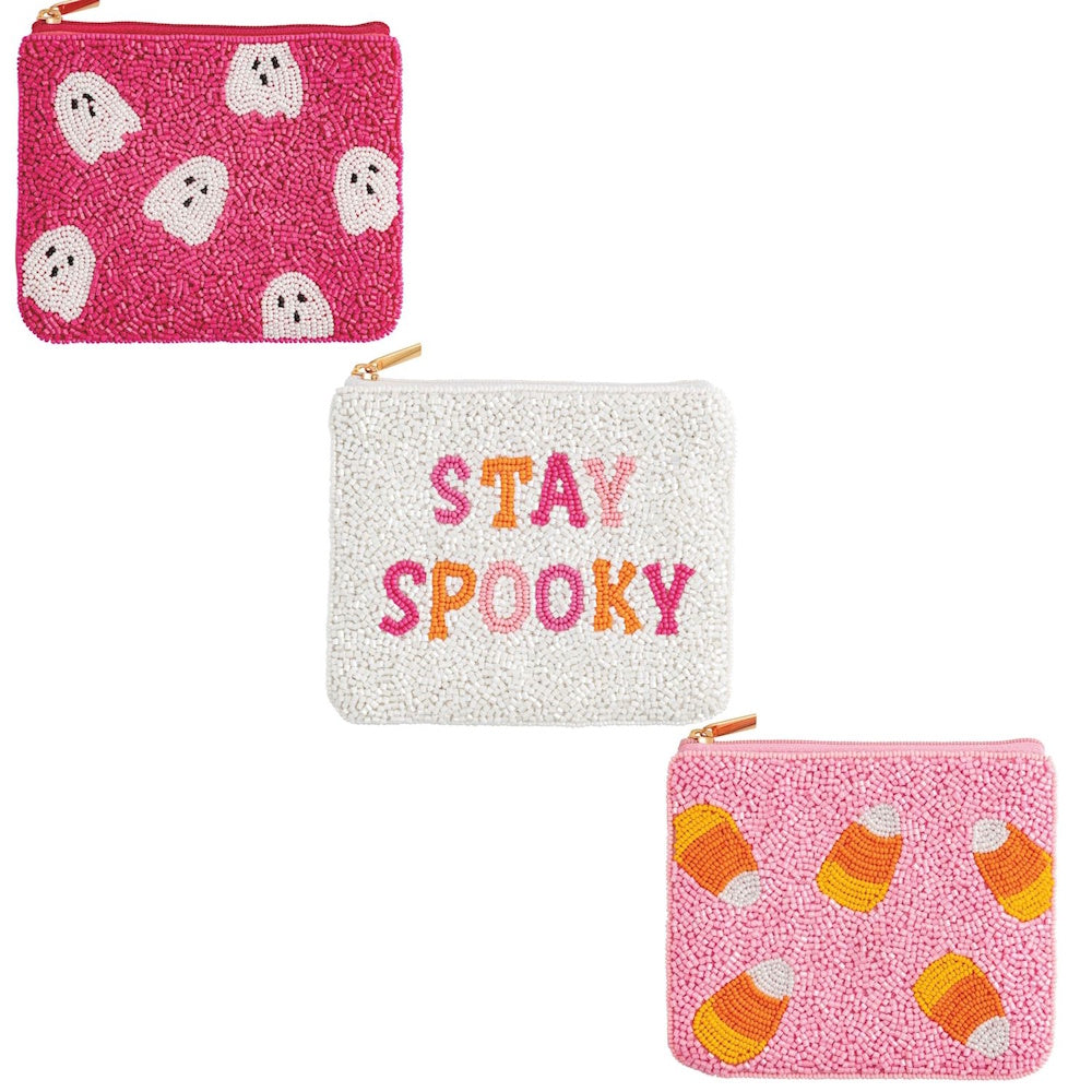 Three Halloween-themed beaded zipper pouches: a pink ghost pattern, "Stay Spooky," and candy corn.