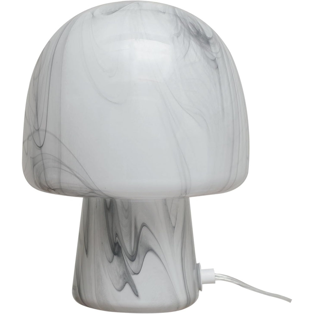 Mushroom-shaped table lamp made of white hand-blown art glass with grey marble-like swirls and a clear power cord.
