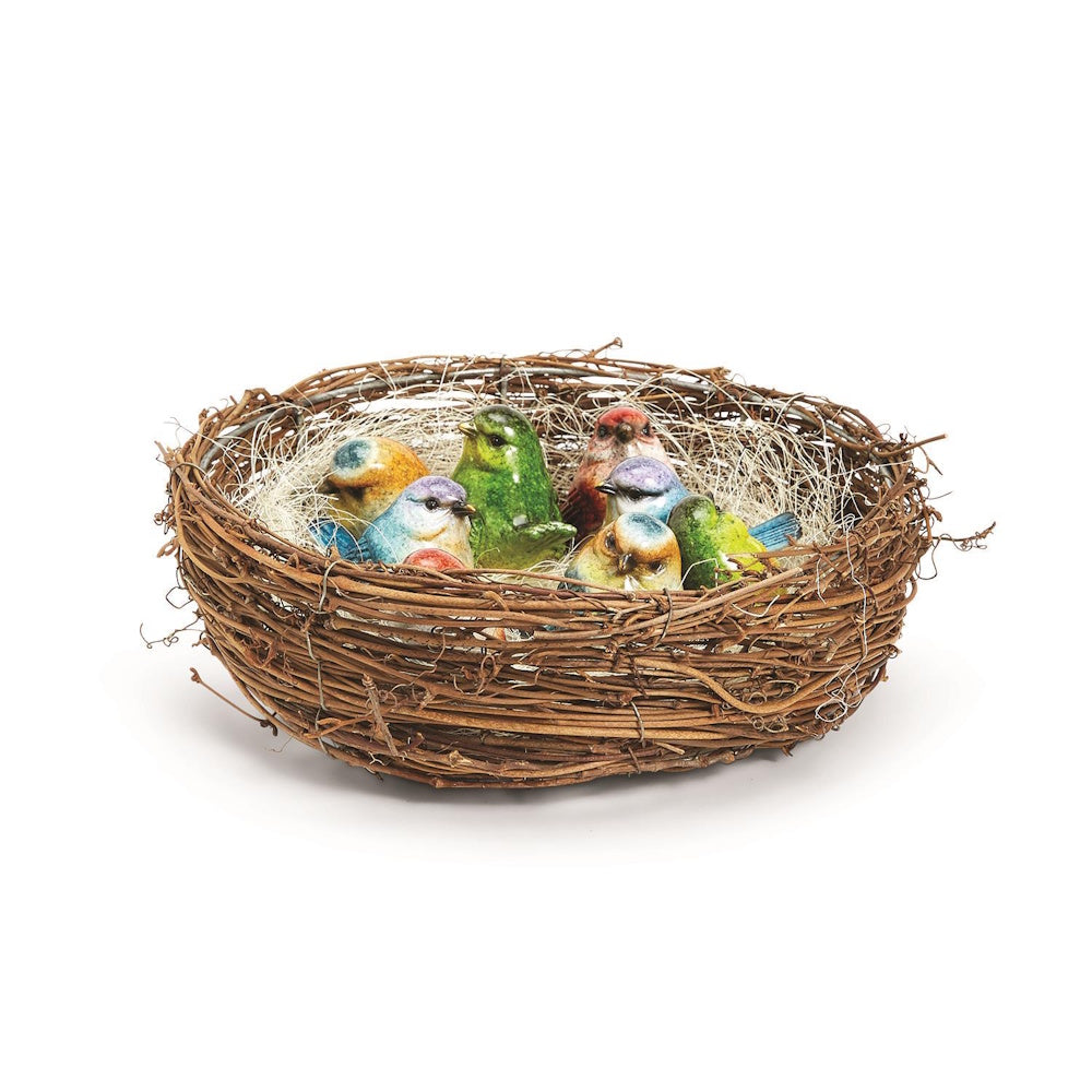 Colorful hand-painted ceramic bird figurines nestled inside a woven twig nest on a white background.