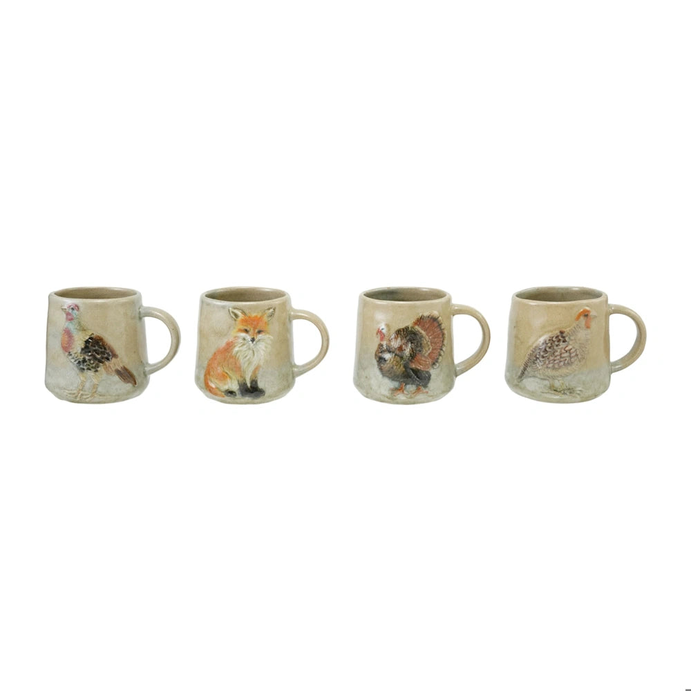 Four rustic ceramic mugs in a row, each embossed with a hand-painted wildlife image: pheasant, fox, turkey, quail.