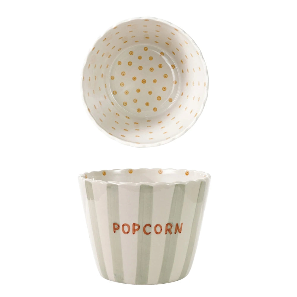 Scalloped ceramic popcorn bowl with sage green stripes on the outside and orange polka dots inside.