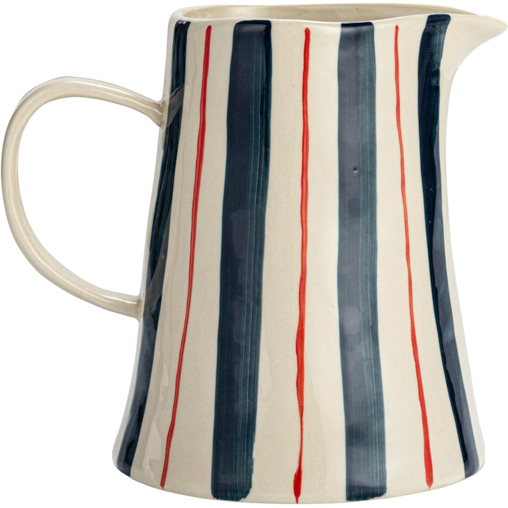 Ceramic pitcher with vertical dark blue and thin orange hand-painted stripes on an off-white background.