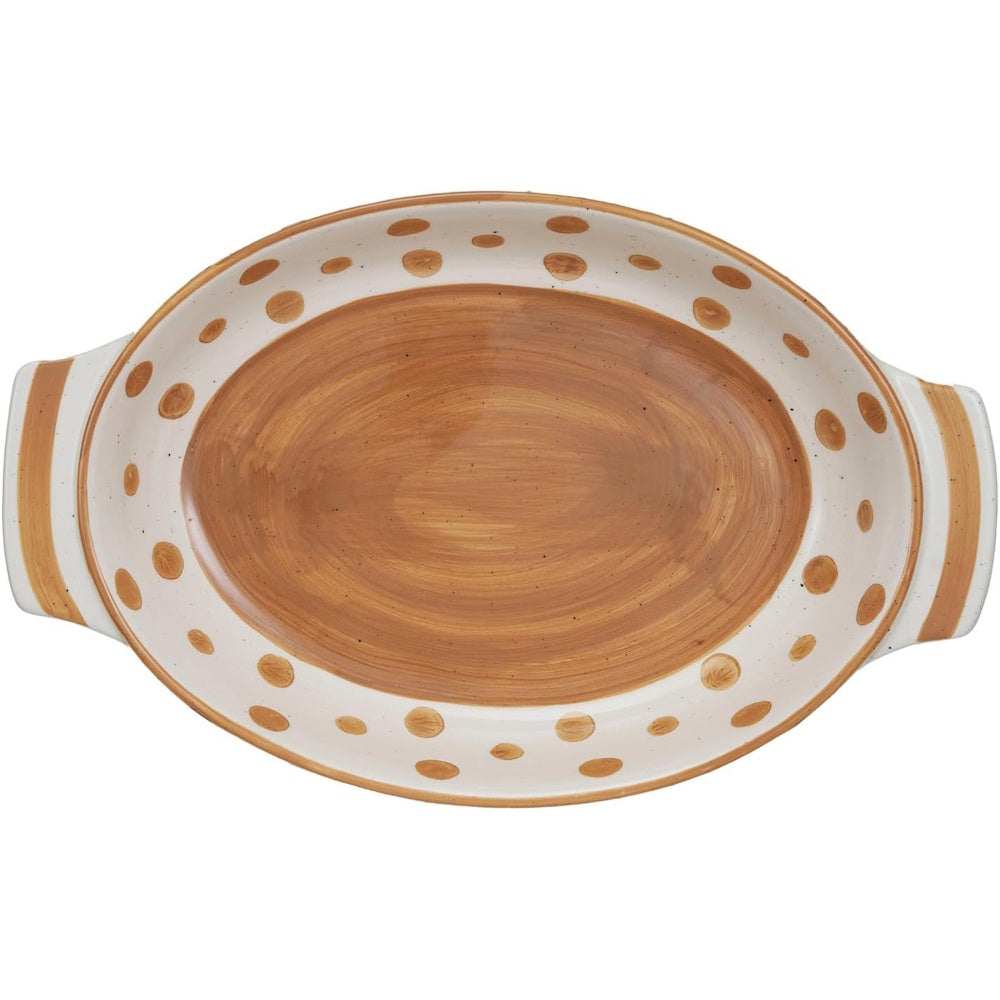 Oval ceramic baking dish with a brown painted center, white rim with brown dots, and handles.