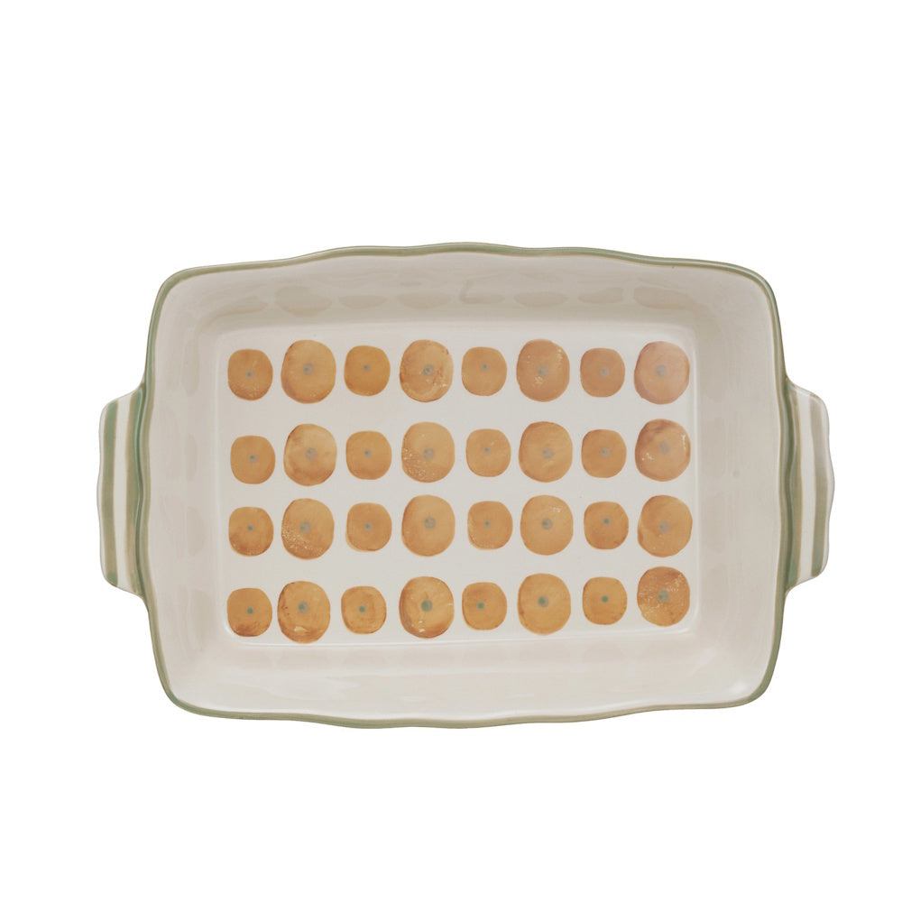 Rectangular white stoneware baking dish with a hand-painted orange polka dot pattern and light green trim.