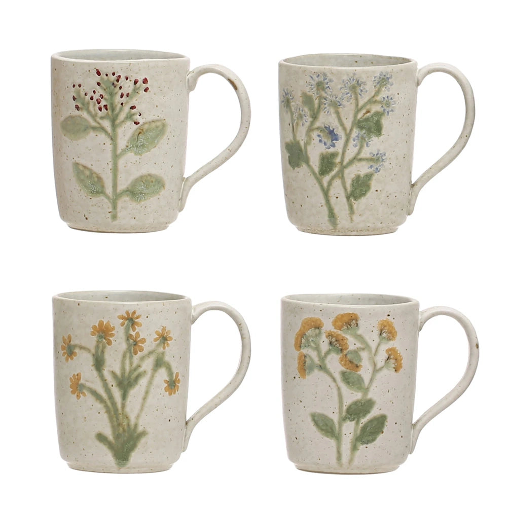 Set of four speckled cream stoneware mugs with embossed botanical branch designs in red, blue, and yellow.