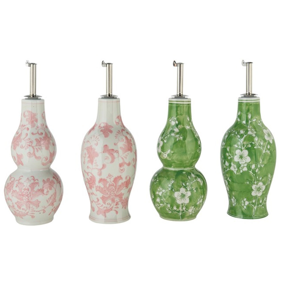 Four stoneware oil cruets with hand-painted floral designs in pink and green, featuring metal pour spouts.