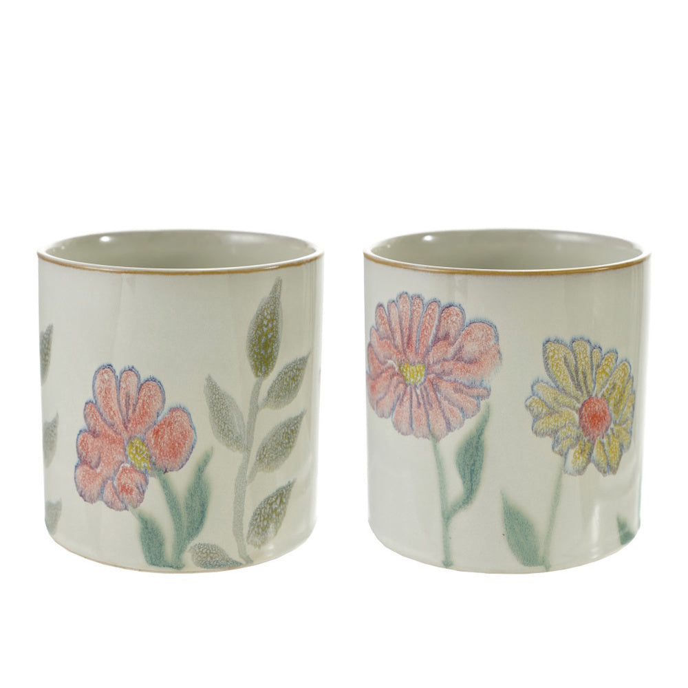 Pair of cylindrical ceramic planters with hand-painted pastel floral and botanical designs.