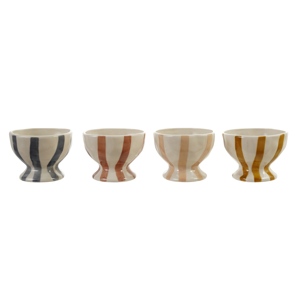 Four hand-painted ceramic footed bowls with vertical stripes in navy, terracotta, peach, and mustard.
