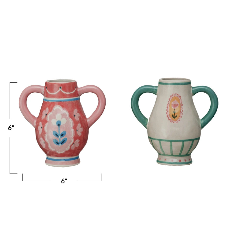 Two hand-painted stoneware urn vases with flower handles in pink and cream, featuring 6-inch height and width dimensions.