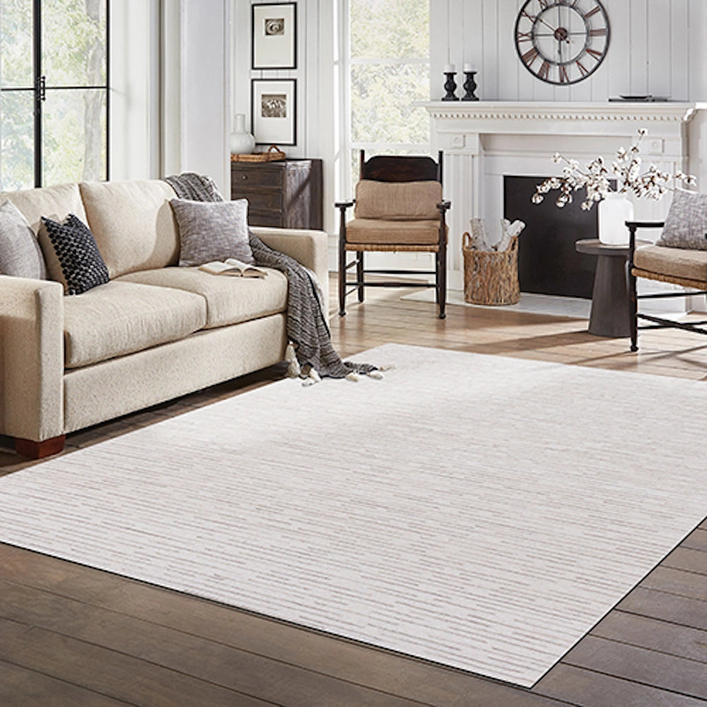 Hand-tufted rectangle Babylon rug in a bright farmhouse living room with a cream sofa and fireplace.