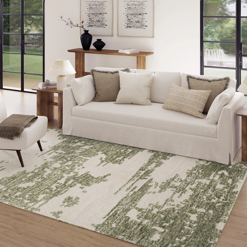 Green and ivory abstract area rug in a bright living room with neutral sofa and modern wood furniture.
