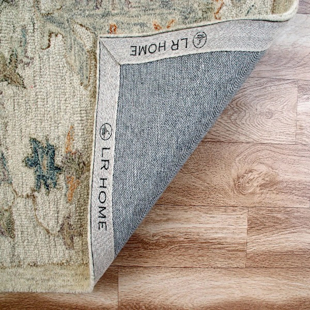 Hand-tufted rectangle vintage ivory rug showing the durable backing material and LR Home border branding.