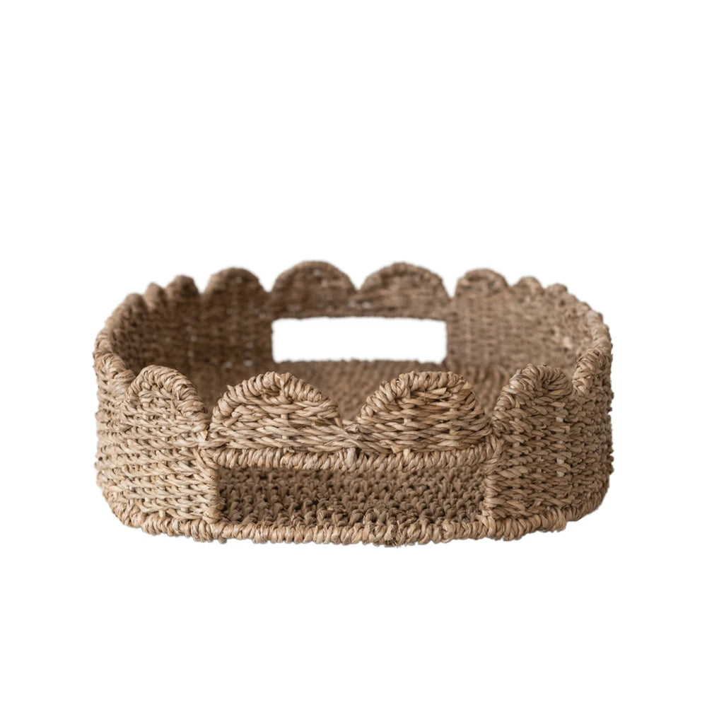Side view of an oval hand-woven scalloped tray showing built-in carrying handles on a plain white background.