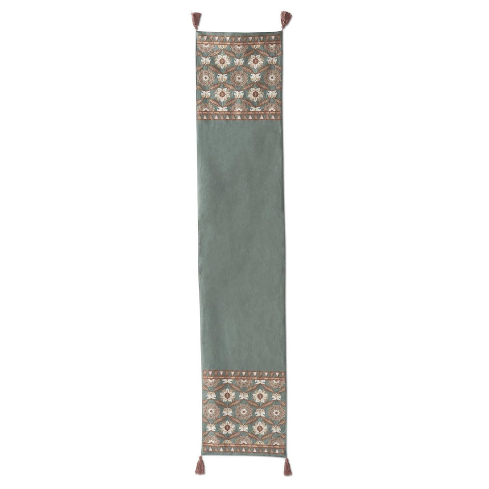 Handcrafted teal table runner with pink embroidered floral patterns and tassels on each corner.