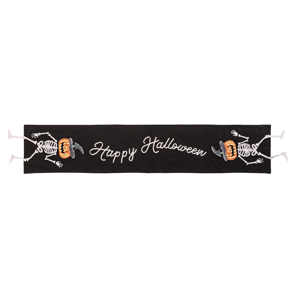 Black Halloween table runner with "Happy Halloween" text, skeletons, and pumpkin-head witches.