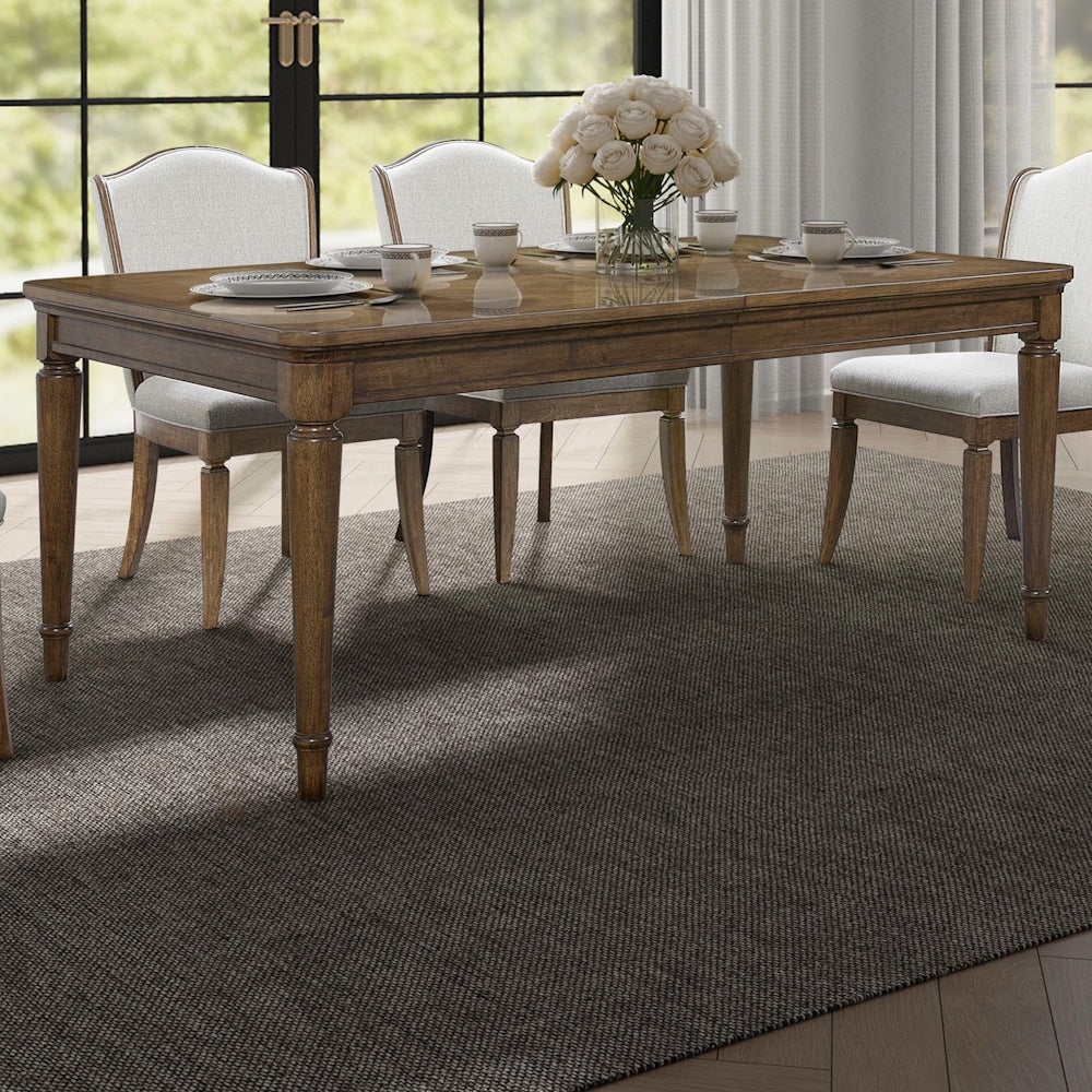 Traditional extendable dining set with wood table, four beige upholstered chairs, and a white rose centerpiece.