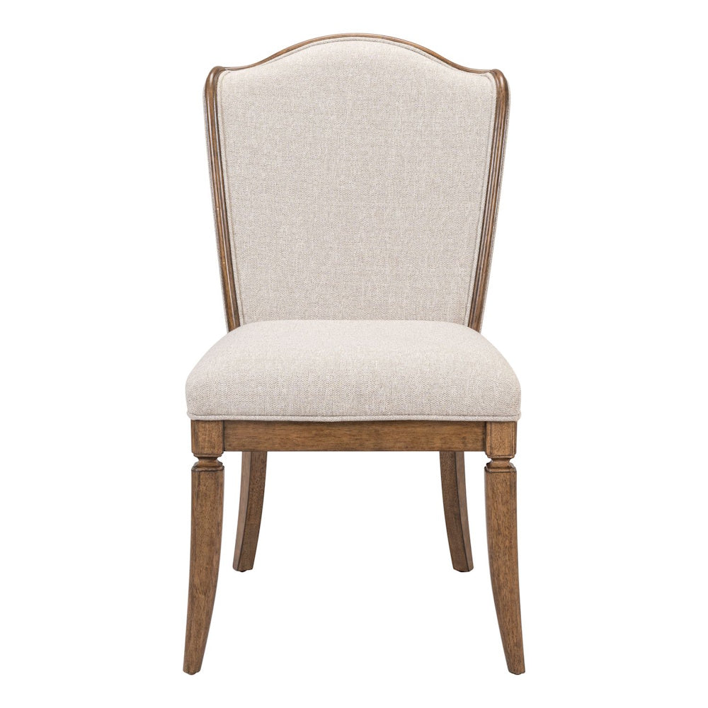 Front view of a beige upholstered dining chair featuring a camelback design, wood trim, and tapered legs on white background.