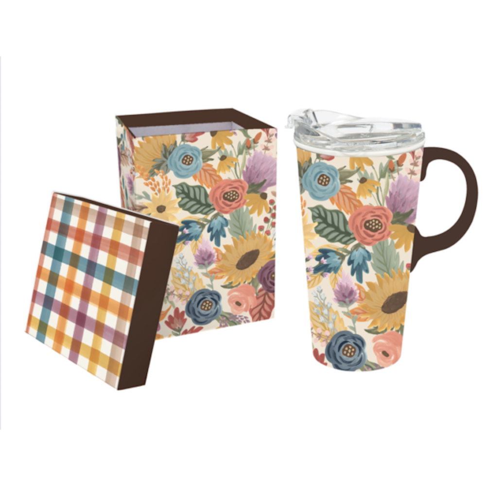 Floral ceramic travel mug with a handle and clear lid next to its matching floral patterned gift box.