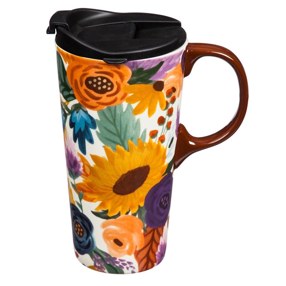Ceramic travel mug with a brown handle and black lid, covered in a vibrant, colorful floral pattern.
