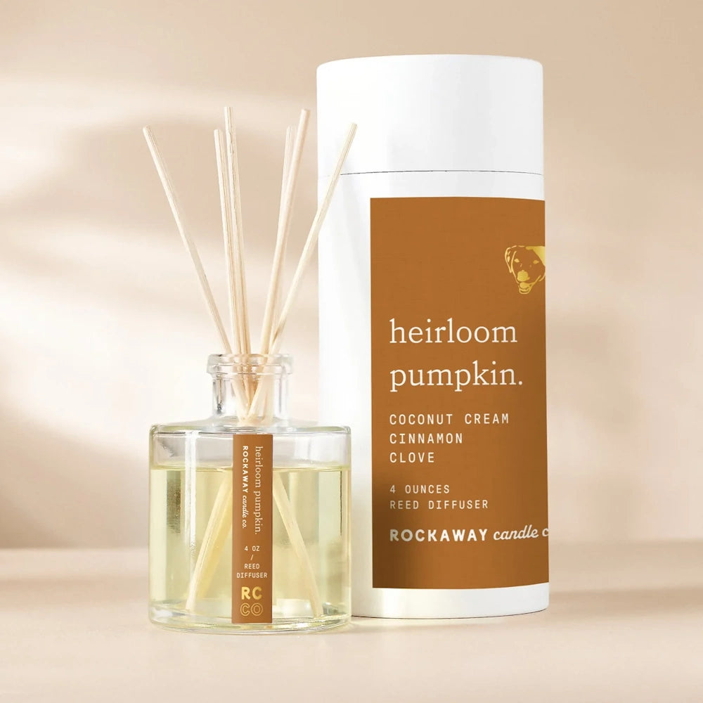 Heirloom pumpkin reed diffuser by Rockaway Candle Co in a clear glass bottle with coconut, cinnamon, and clove.