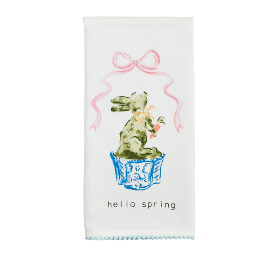 White towel featuring a green bunny holding a carrot below a pink ribbon with the text "hello spring."