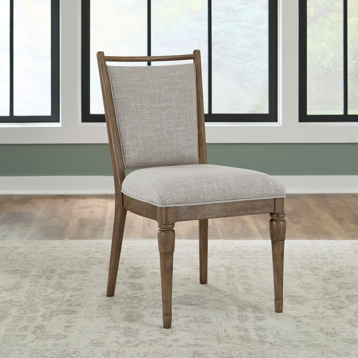 Hickory Grove upholstered dining chair with a gray fabric seat and turned wooden legs in a bright room.