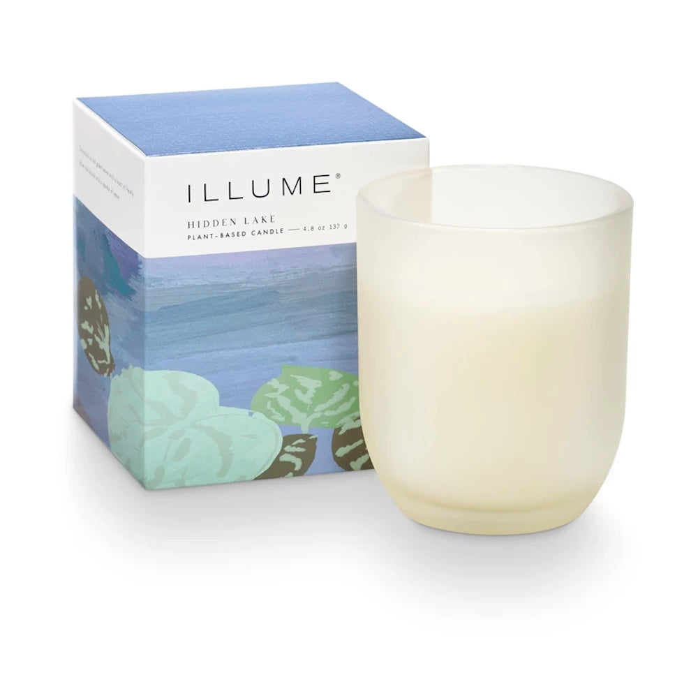 Illume Hidden Lake plant-based candle in a frosted glass jar with its decorative blue lily pad box.