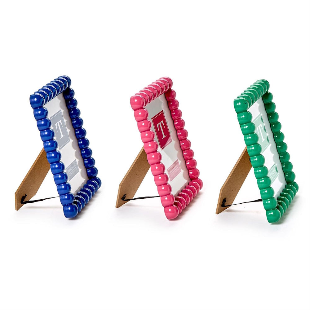 Three glossy beaded photo frames in blue, pink, and green, displayed side-by-side with easel backs.
