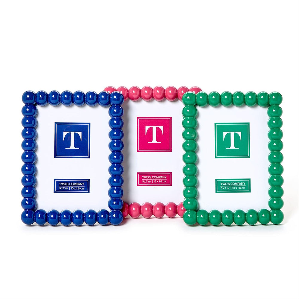 Three colorful beaded picture frames in blue, pink, and green lined up against a white background.