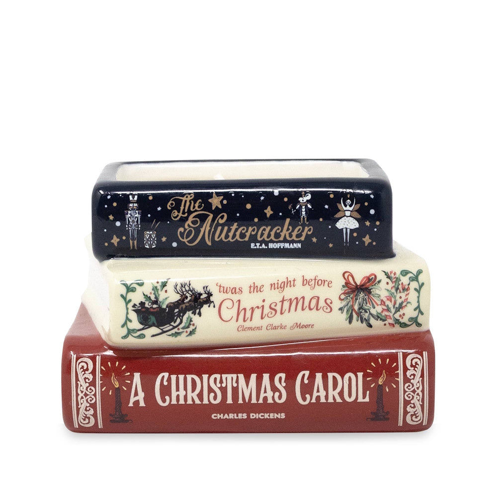 Stacked ceramic book candle with spines for The Nutcracker, Night Before Christmas, and A Christmas Carol.