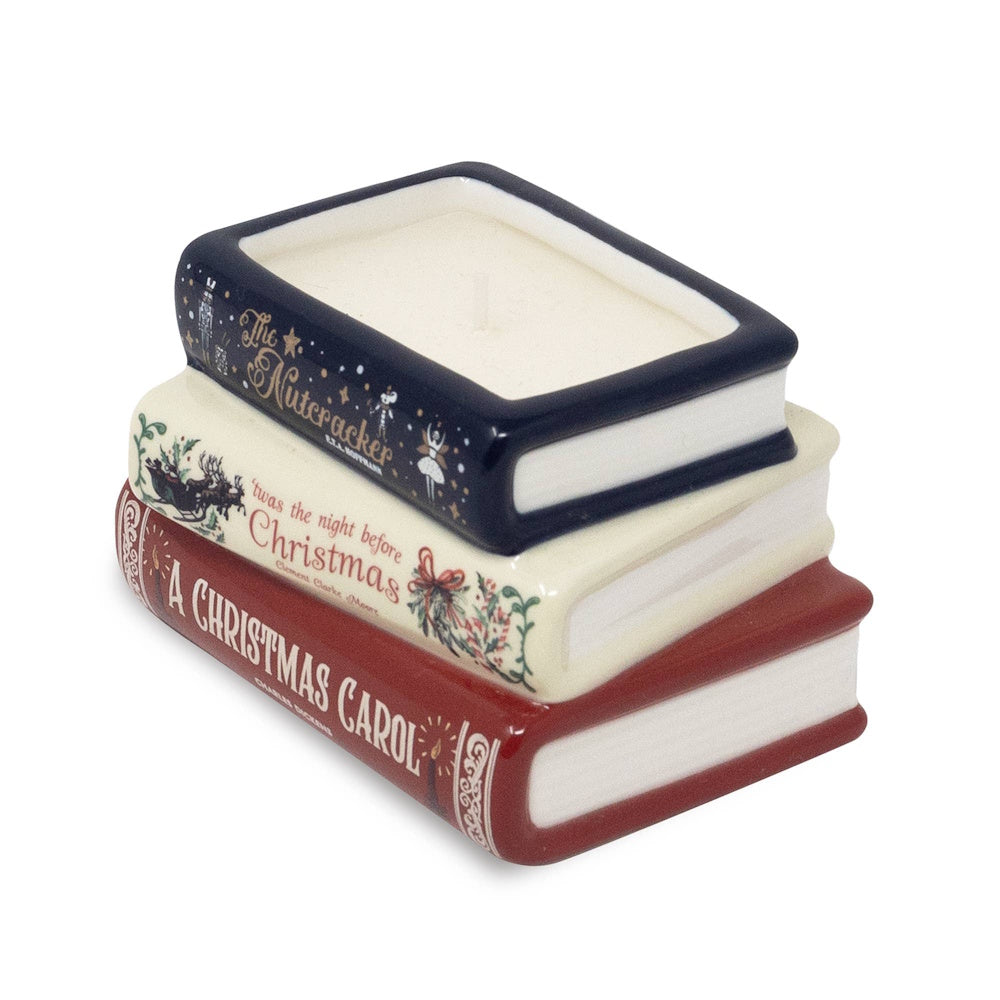 Stacked ceramic books candle featuring classic holiday story titles.