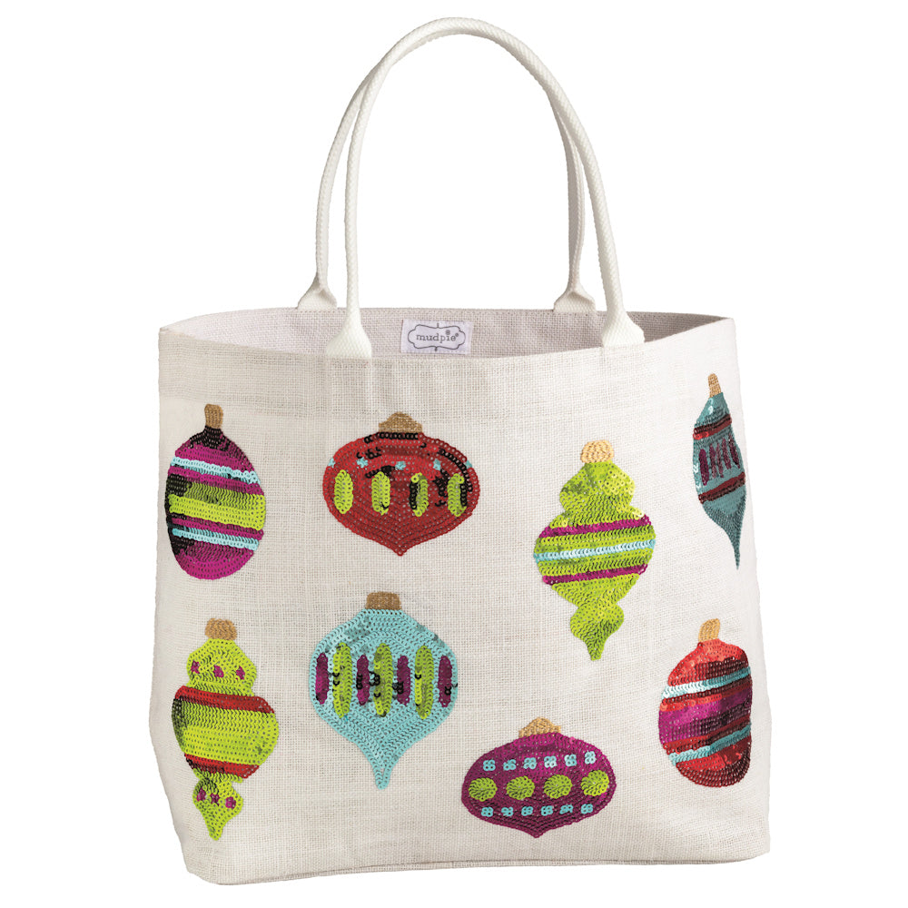 White Mud Pie burlap tote bag featuring colorful sequined Christmas ornament designs with white canvas rope handles.
