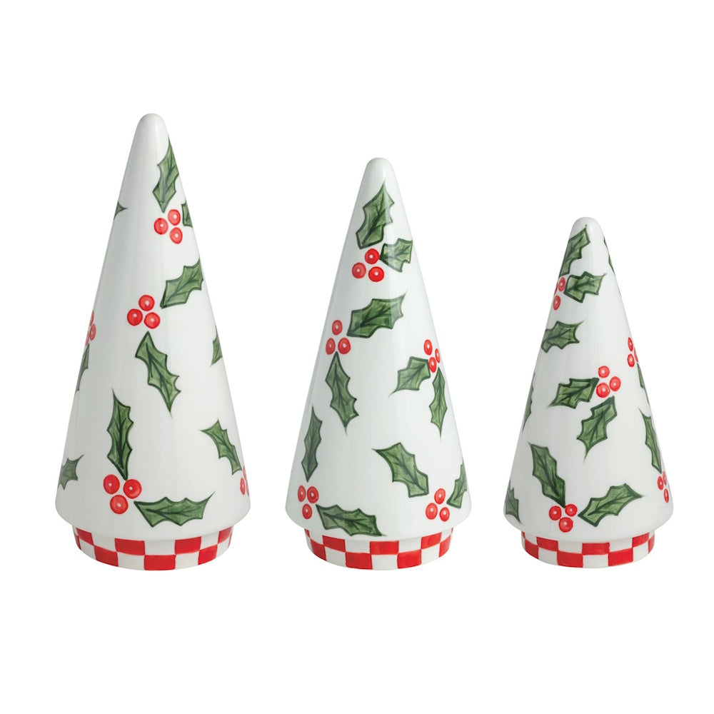 Set of three white ceramic cone trees with painted holly patterns and red-and-white checkered bases.