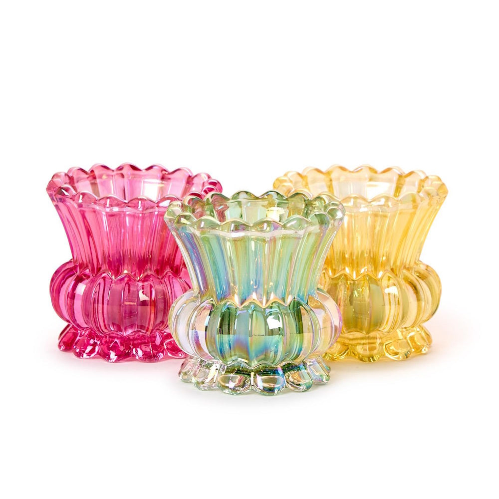 Three small iridescent glass vases in pink, iridescent green, and yellow with scalloped edges on a white background.