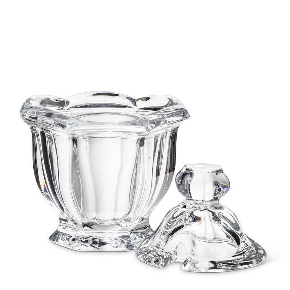 Clear crystal glass jam jar with a matching lid removed and resting beside it on a white background.