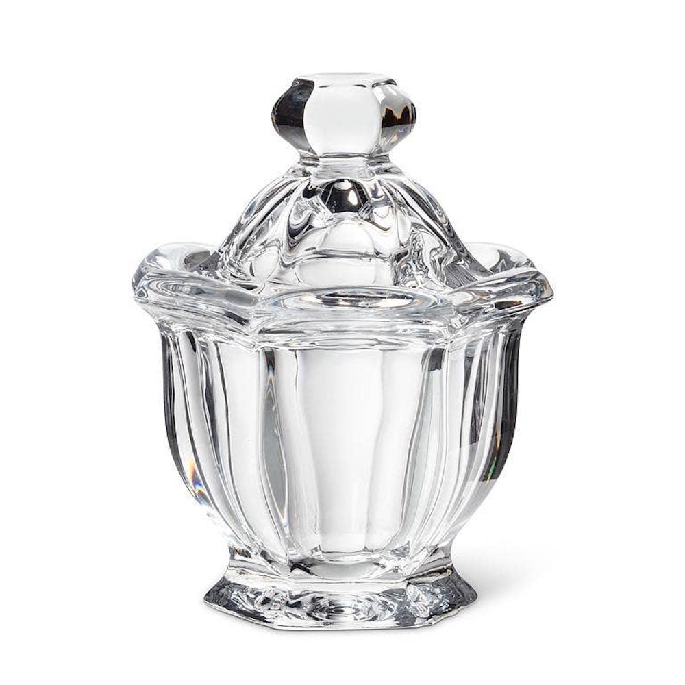 Clear crystal jam jar or sugar bowl with a matching ornate lid on a white background.