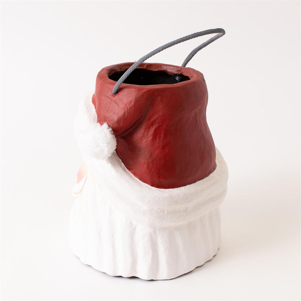 Side view of a paper-mâché Santa Claus head bucket container with a grey cord handle.