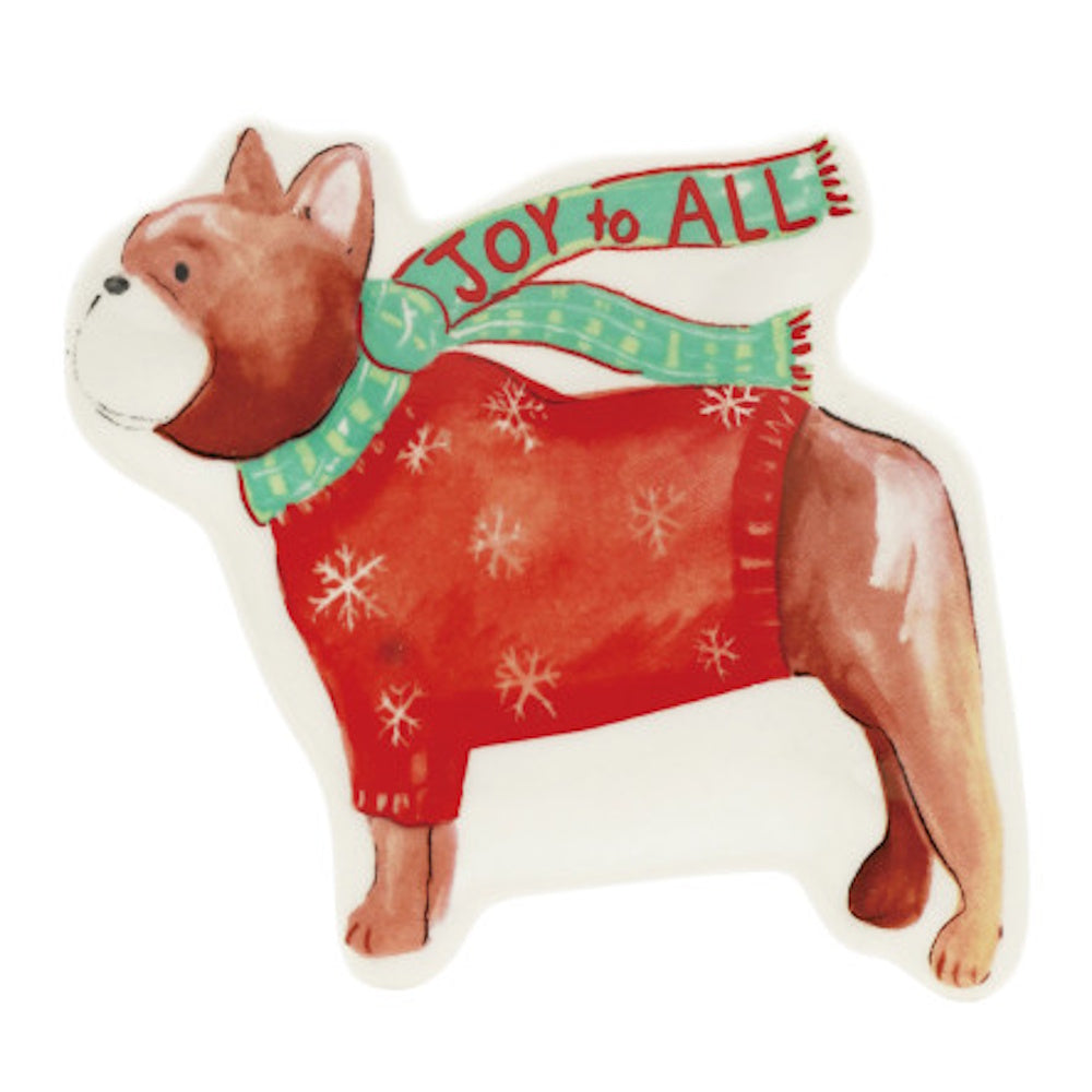 A stoneware dog dish shaped like a French bulldog wearing a red snowflake sweater and a green scarf.
