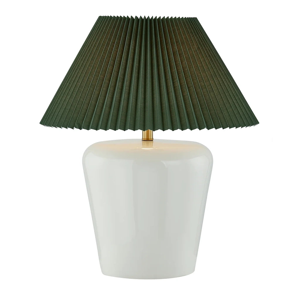 Glossy white ceramic table lamp with dark green pleated shade and brass accent for modern decor.