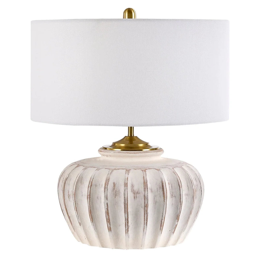 Ribbed ceramic table lamp with a rustic white finish, gold accents, and a fabric drum shade.