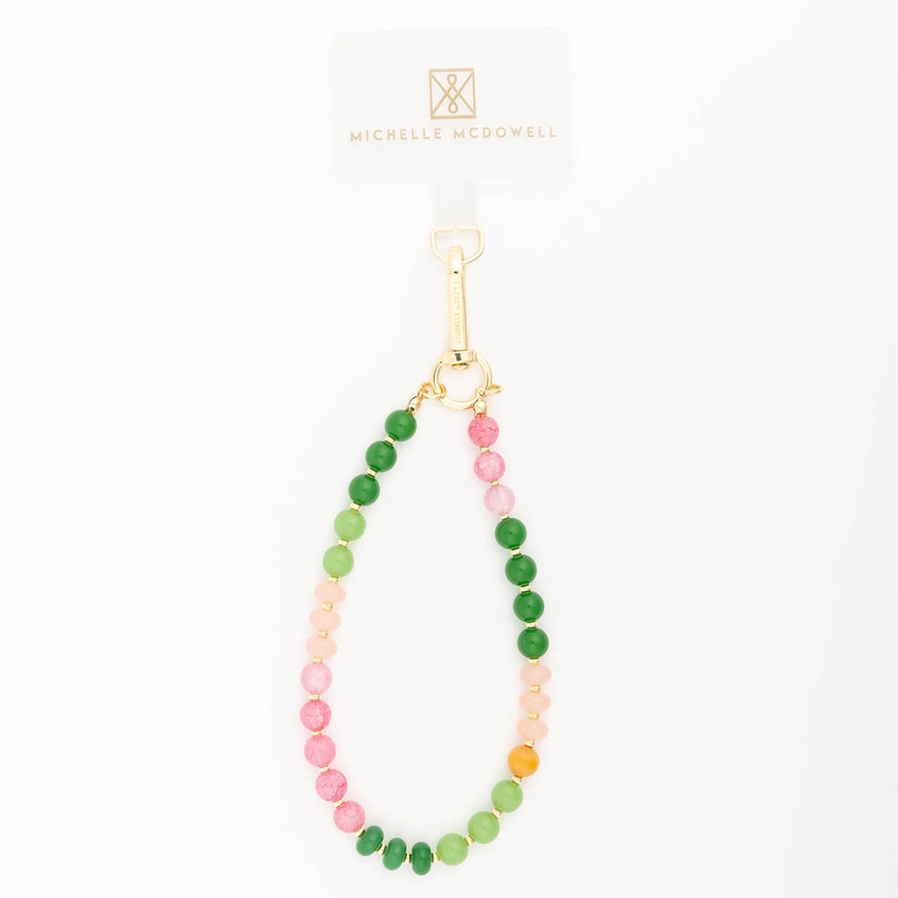 Beaded phone charm strap with pink, green, and gold beads on a white background.