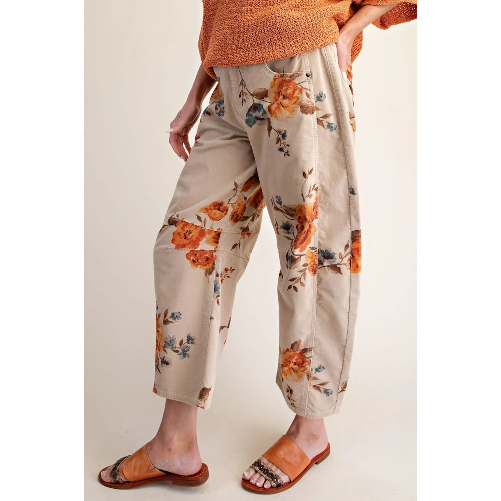 Side view of khaki floral corduroy barrel pants paired with orange sandals.