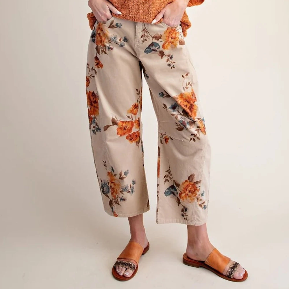 Khaki floral corduroy barrel pants worn with brown sandals from the front.