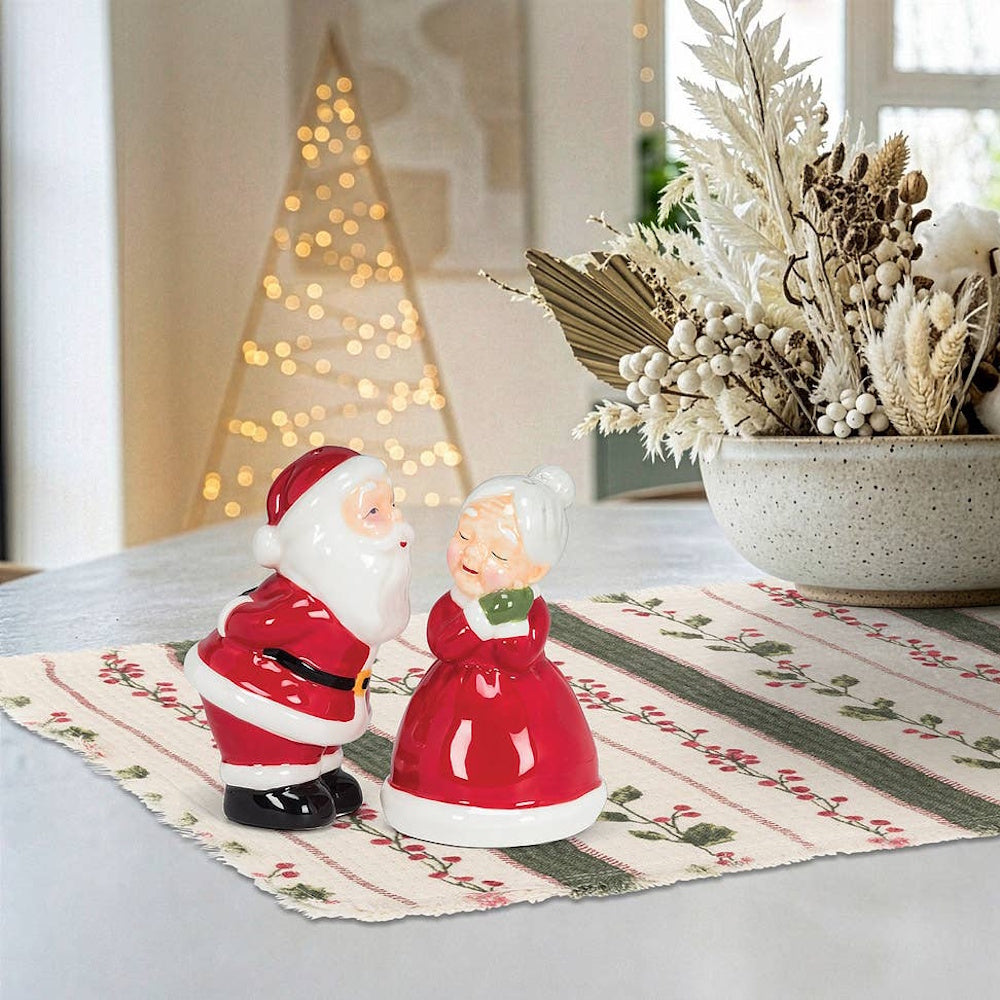 Ceramic Santa and Mrs. Claus salt and pepper shaker set styled in a kissing pose.