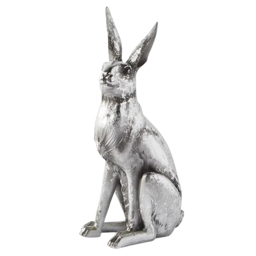 A rustic silver hare figurine with long ears, sitting upright against a solid black background.