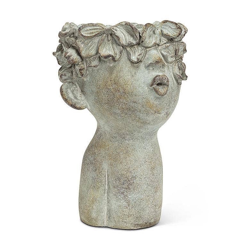 Stone-look cement head planter with pouting lips and a flower crown rim.