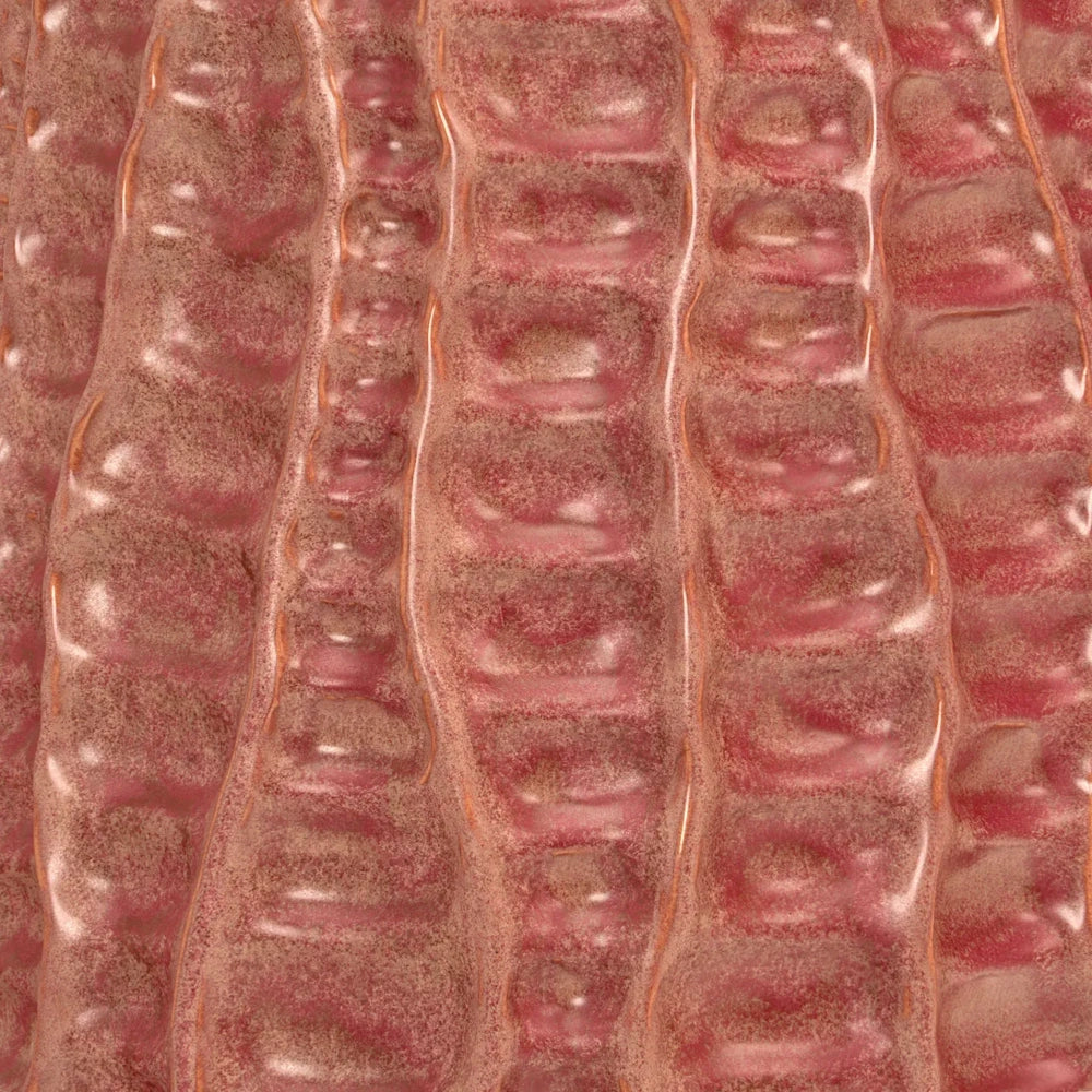Close-up of a pink, textured surface with vertical, wavy ridges and a dusty, speckled finish.