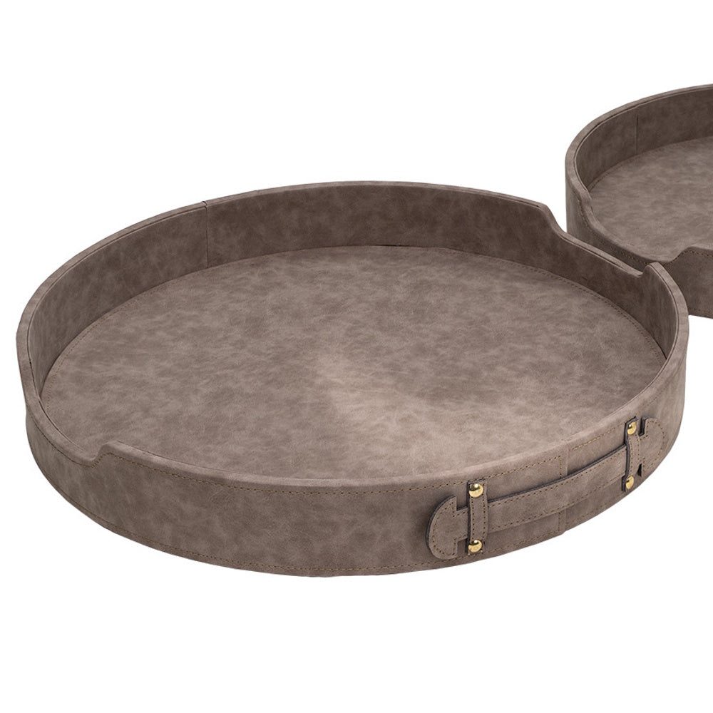 Large round grey faux-leather serving tray with side handles and gold studs on a white background.